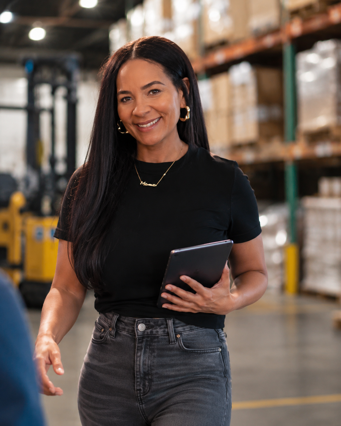 Regional Now team member with a tablet walking the warehouse floor